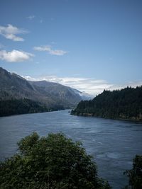 Scenic view of sea and mountains against sky