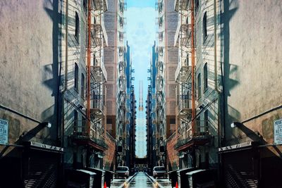 Symmetrical image of street amidst buildings in city