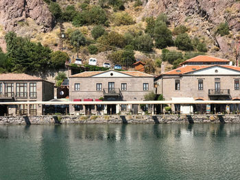 Buildings by river in town