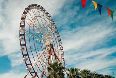 Low angle view of ferris wheel against sky