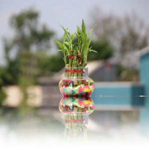 Close-up of multi colored glass with water on table