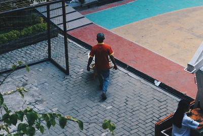 High angle view of men walking on footpath