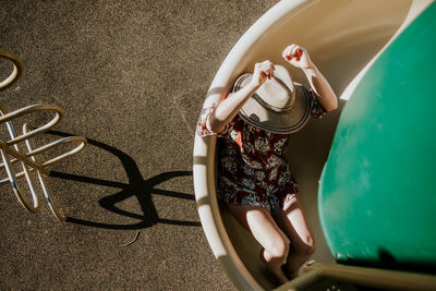 Overhead view of a woman sliding down a spiral slide