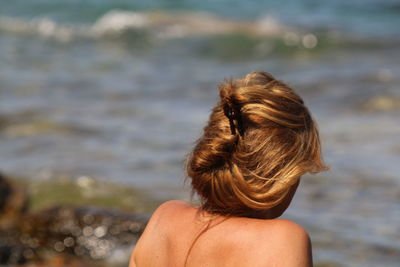 Rear view of woman against sea