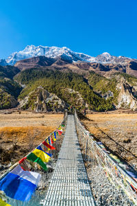 Scenic view of mountains against clear blue sky