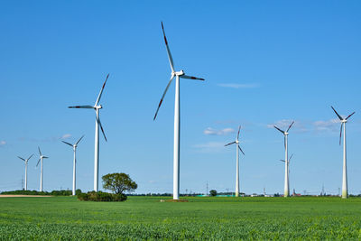 Modern wind energy turbines in a cornfield seen in germany