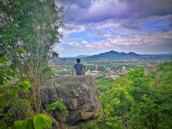 Man standing by plants against sky