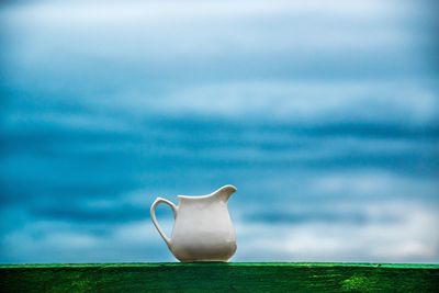 Close-up of cup against sky