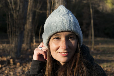 Close-up portrait of young woman wearing hat