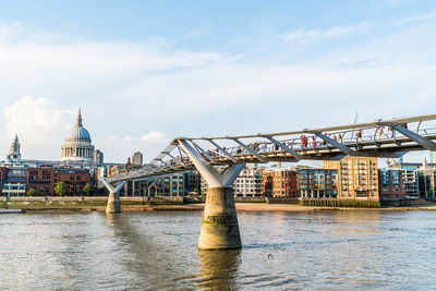 Bridge over river with buildings in background