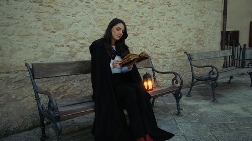 Portrait of young woman sitting on chair