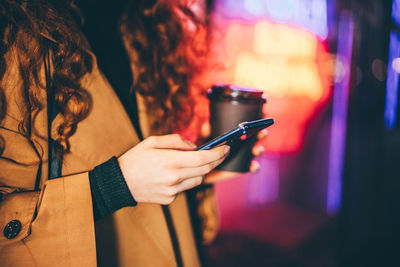 Midsection of woman using mobile phone