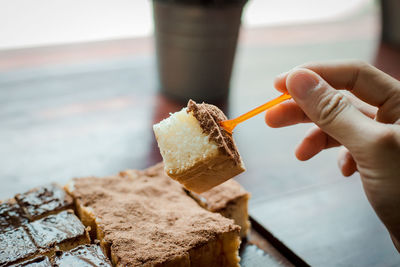 Close-up of hand holding ice cream