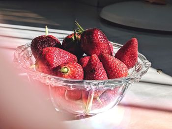 Close-up of strawberries in glass bowl on table