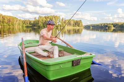 Rear view of man kayaking in lake