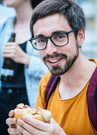 Close-up portrait of man eating burger