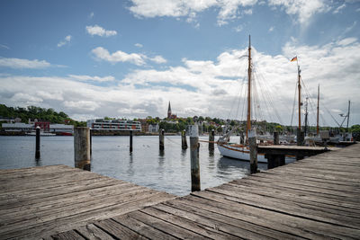 Pier on lake against sky