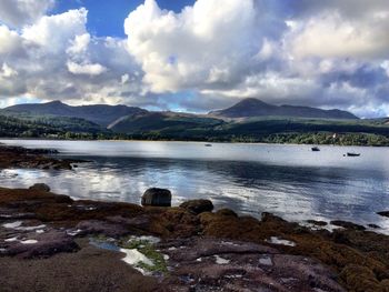 Scenic view of lake against cloudy sky