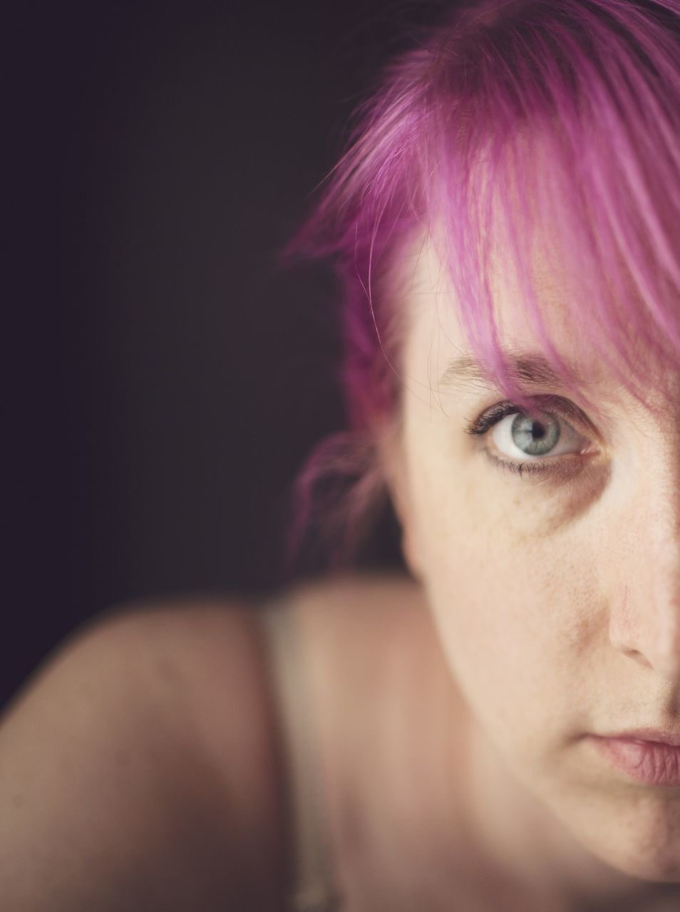 headshot, close-up, young adult, human face, studio shot, lifestyles, looking at camera, portrait, human eye, front view, person, part of, black background, indoors, young women, leisure activity