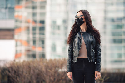 Woman wearing mask while standing outdoors