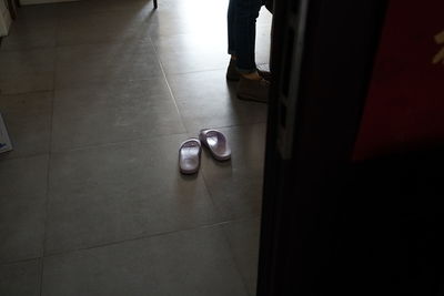 Low section of person walking on tiled floor