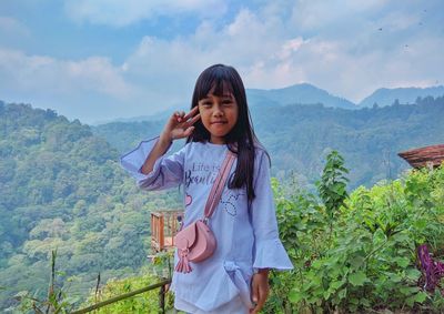 Little girl posing on a beautiful mountain