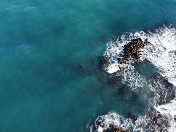 High angle view of rocks in sea