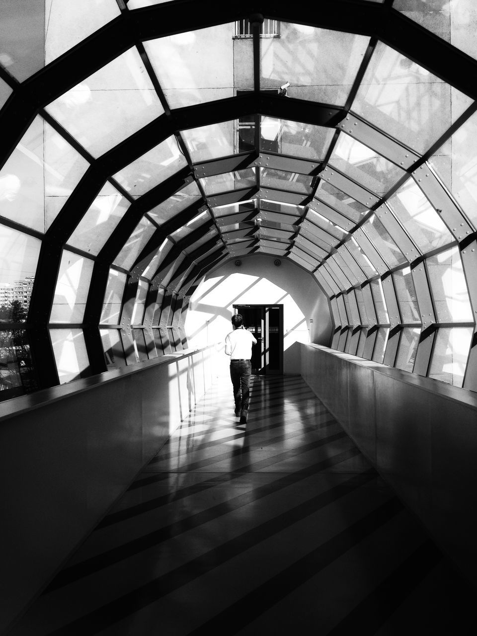 real people, architecture, indoors, built structure, walking, lifestyles, arch, the way forward, men, silhouette, rear view, leisure activity, modern, transportation, one person, women, full length, day, people