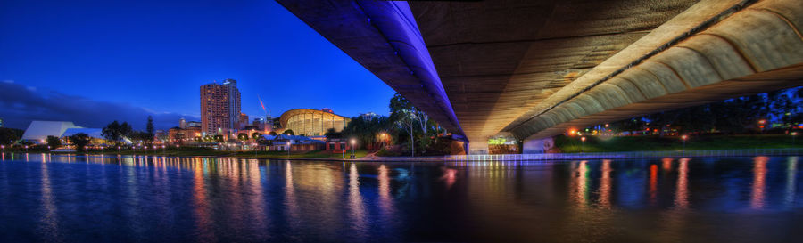 View of bridge over river at night