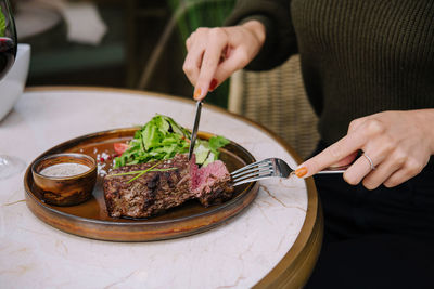 Cropped hand of person preparing food