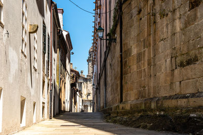 Narrow street amidst buildings against sky