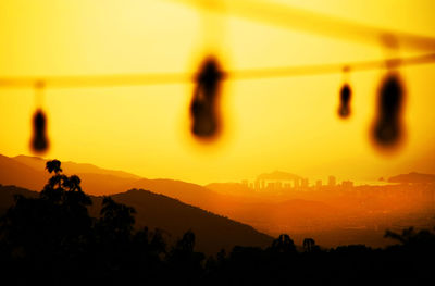 Scenic view of landscape against orange sky