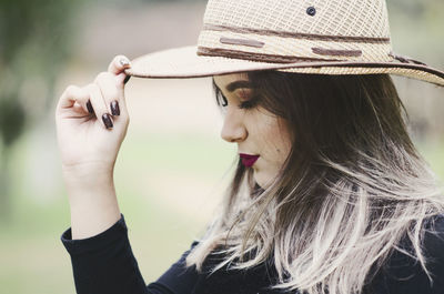 Portrait of young woman wearing hat