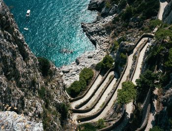 High angle view of rock formations at seaside