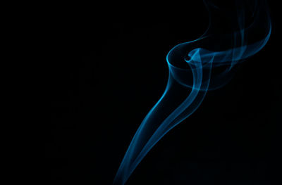 Close-up of smoke against blue background