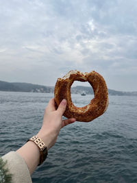 Cropped hand of person holding seashell