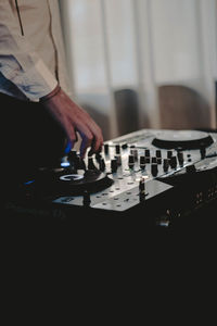 Midsection of woman using smart phone at home