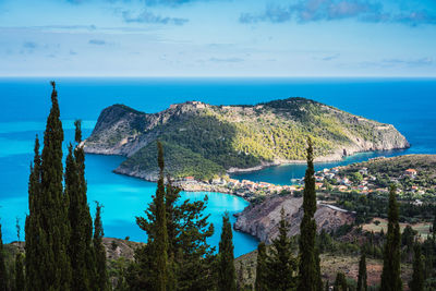 Scenic view of mountain in sea against sky