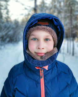 Portrait of a boy in winter clothes outdoors