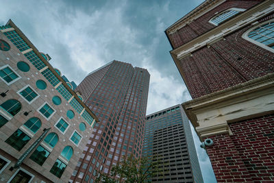 Low angle view of modern buildings against sky in city