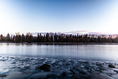 Scenic view of frozen lake against sky during winter