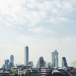 City skyline against cloudy sky