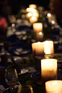 Close-up of illuminated tea light candles on table