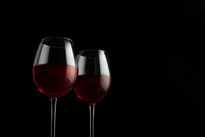 Glass of wine against black background