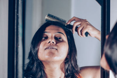 Close-up portrait of woman at home