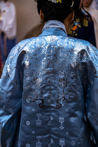 Rear view of woman wearing kimono while standing outdoors