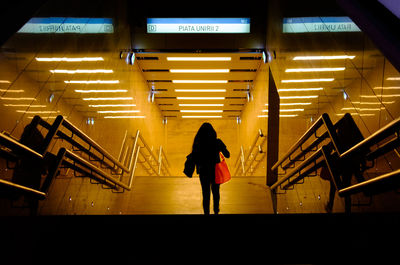 Silhouette woman walking at station