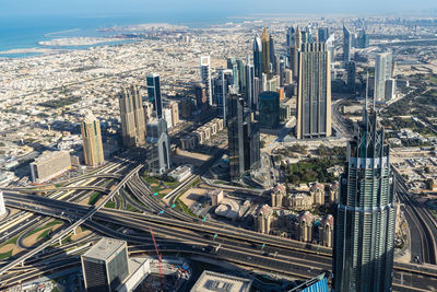 High angle view of modern buildings in city against sky