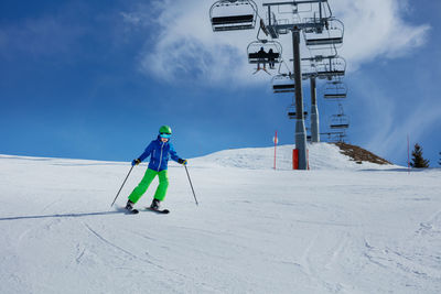 Low angle view of man skiing on snow covered landscape