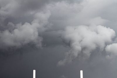 Low angle view of smoke stack against sky